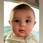 Shawn is registered to the contest to win money with this photo: baby, infant, face, eyes, mouth, clothing, car_interior, seat, child, person, cute, young, portrait, skin, hair, head, light, window, expression, closeup