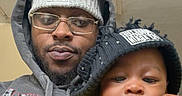 Kasai joined the competition — help win amazing prizes! adult, baby, beanie, casual_clothing, child, cozy, cute, face, foot, glasses, hand, hoodie, indoor, infant, matching_hats, person, portrait, relaxed, selfie, yellow_shirt