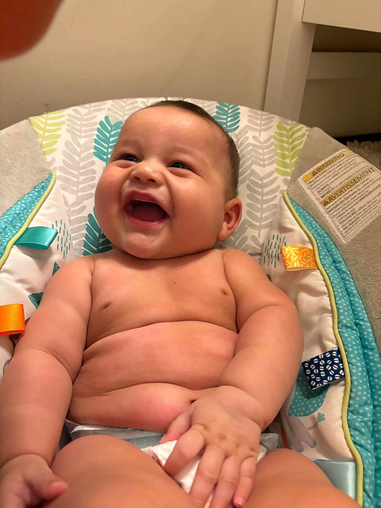 Ryker is registered to the contest to win money with this photo: baby, laughing, chubby, diaper, infant, cushion, seat, colorful, pattern, leaf_pattern, happy, skin, hand, arm, torso, indoor, child, cute, smile, portrait