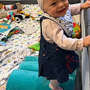 éléna participe au concours pour gagner de l'argent avec cette photo : baby, baby_girl, blanket, cheerful, child, clothing, colorful, cushion, cute, denim_dress, happy, headband, indoor, play_area, playpen, smiling, soft_texture, standing, toddler, toys