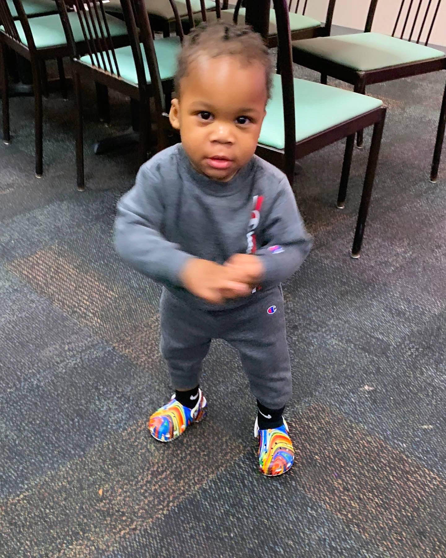 Zyaire joined the competition — help win amazing prizes! baby, baby_toddler_clothing, chair, child, electric_blue, face, floor, flooring, fun, happy, hardwood, head, pattern, person, sitting, sleeve, smile, t_shirt, toddler, white