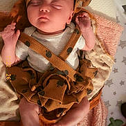 Lila is registered to the contest to win money with this photo: baby, sleeping, crib, blanket, hat, polka_dot, clothing, infant, soft_texture, cute, cozy, nursery, star_pattern, child, resting, newborn, indoors, person, cute_outfit, peaceful