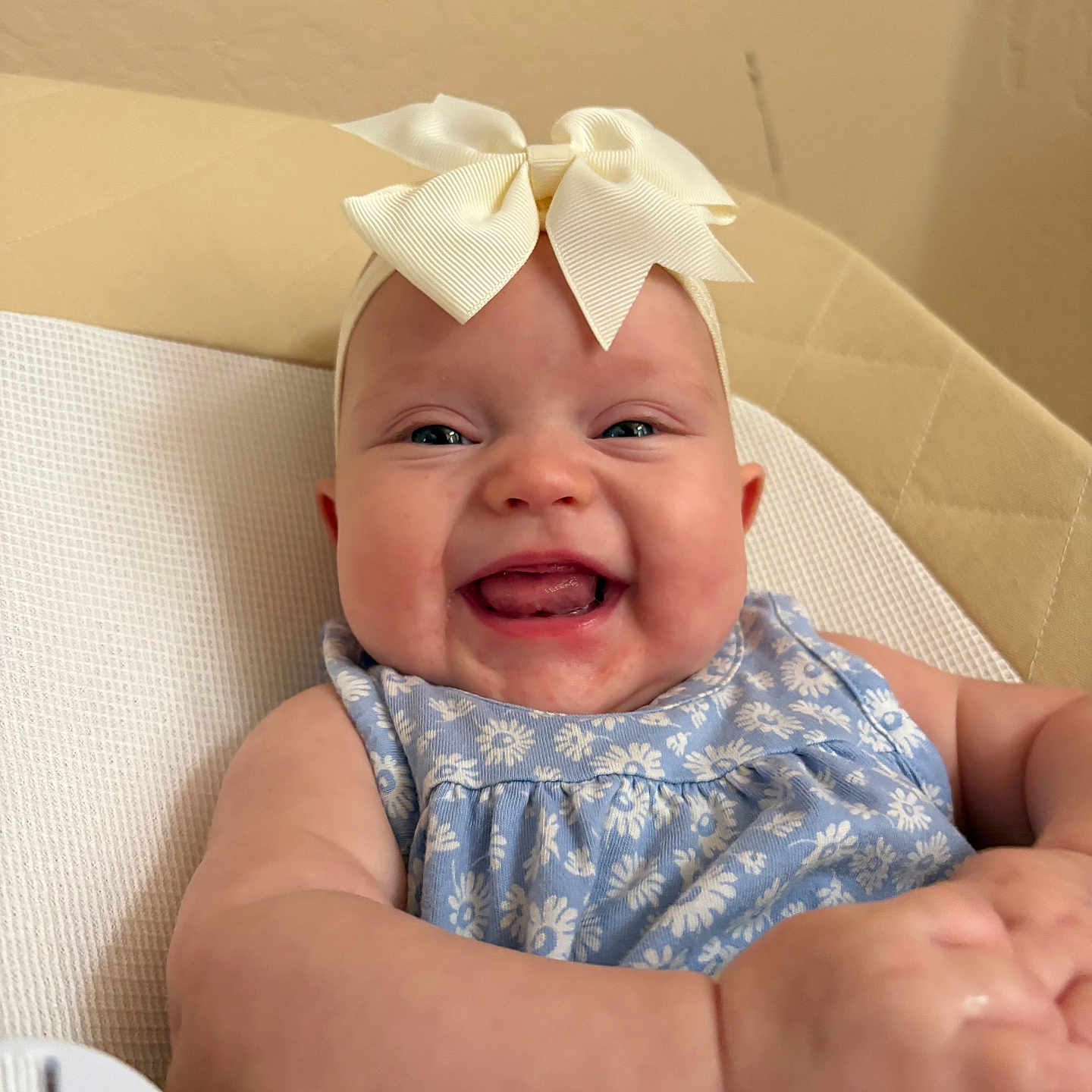 Summer joined the competition — help win amazing prizes! baby, smile, headband, bow, blue_dress, floral_pattern, happy, infant, child, cushion, beige_background, portrait, closeup, cute, sitting, skin, face, hand, indoors, cheerful