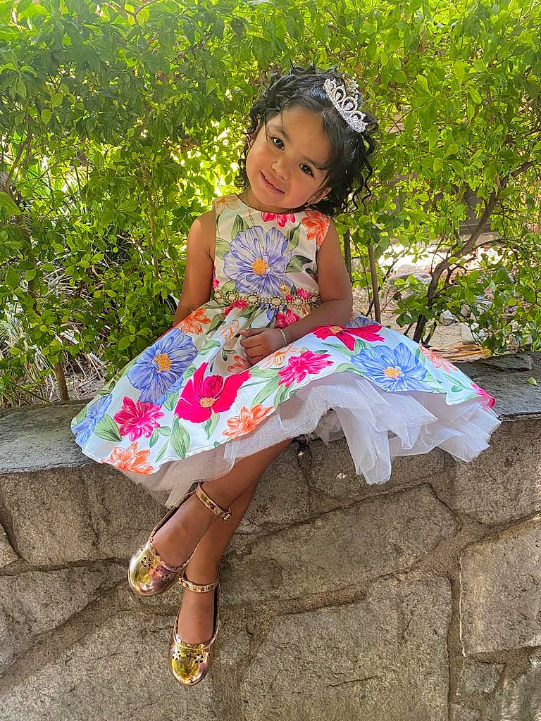 Victoria is registered to the contest to win money with this photo: baby_toddler_clothing, child, day_dress, dress, embellishment, face, fun, grass, happy, human_body, joy, leg, leisure, magenta, people_in_nature, person, pink, plant, sandal, smile