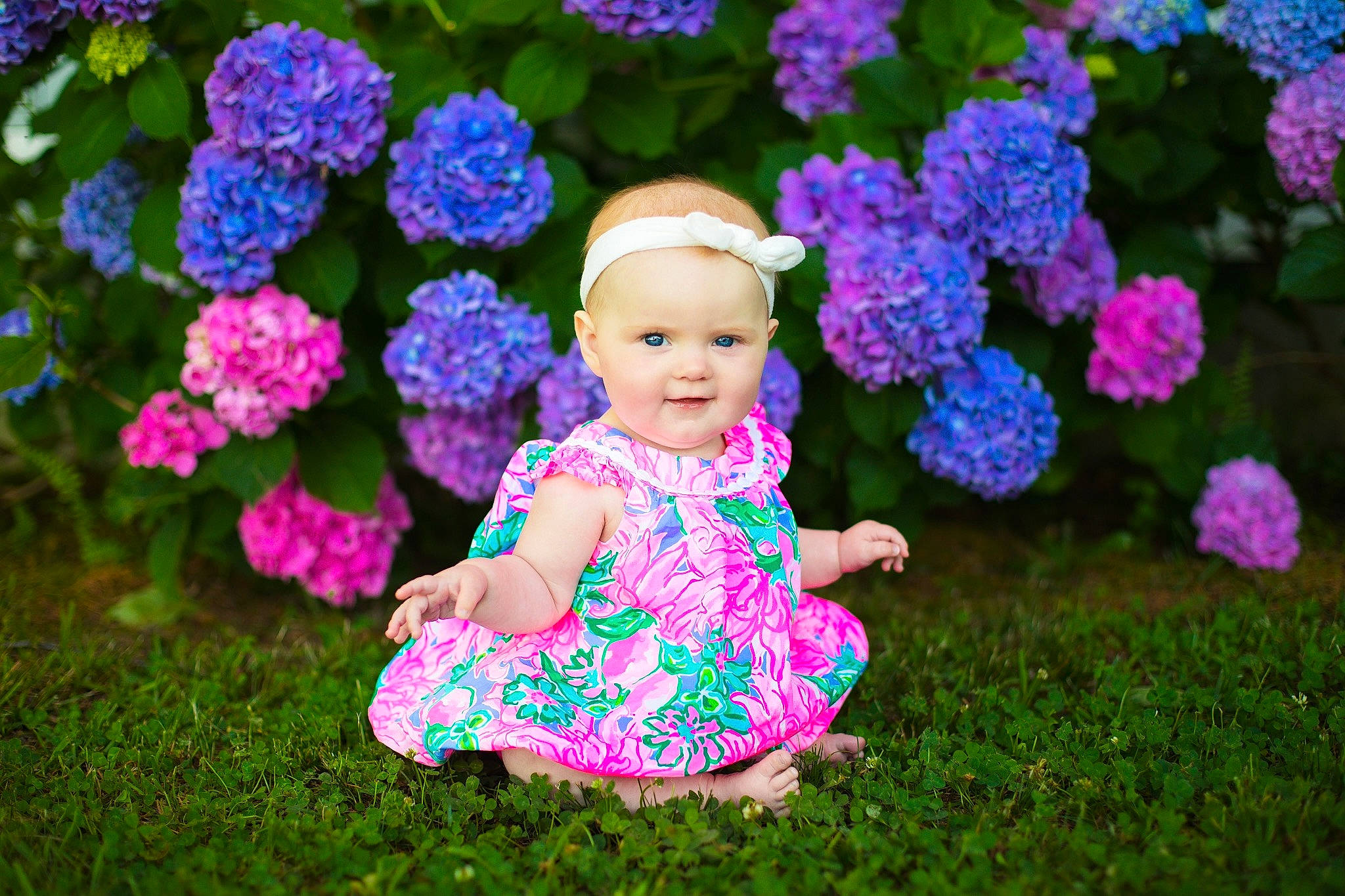 Charlotte is registered to the contest to win money with this photo: baby_toddler_clothing, blue, botany, flower, grass, happy, hat, leaf, leisure, magenta, mammal, nature, people_in_nature, person, petal, pink, plant, purple, smile, toddler
