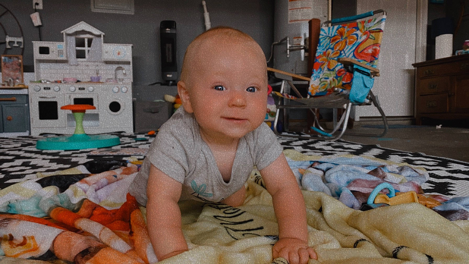 Koby is registered to the contest to win money with this photo: art, baby, baby_toddler_clothing, carpet, cheek, child, comfort, crawling, flooring, fun, linens, people, person, play, room, sitting, smile, toddler, vacation, visual_arts