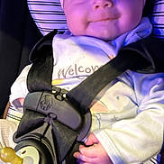 Sarajean joined the competition — help win amazing prizes! baby, car_seat, headband, pacifier, clothing, straps, happy, smile, infant, child, hand, seatbelt, close_up, portrait, indoor, comfort, young_child, face, cuteness, safety