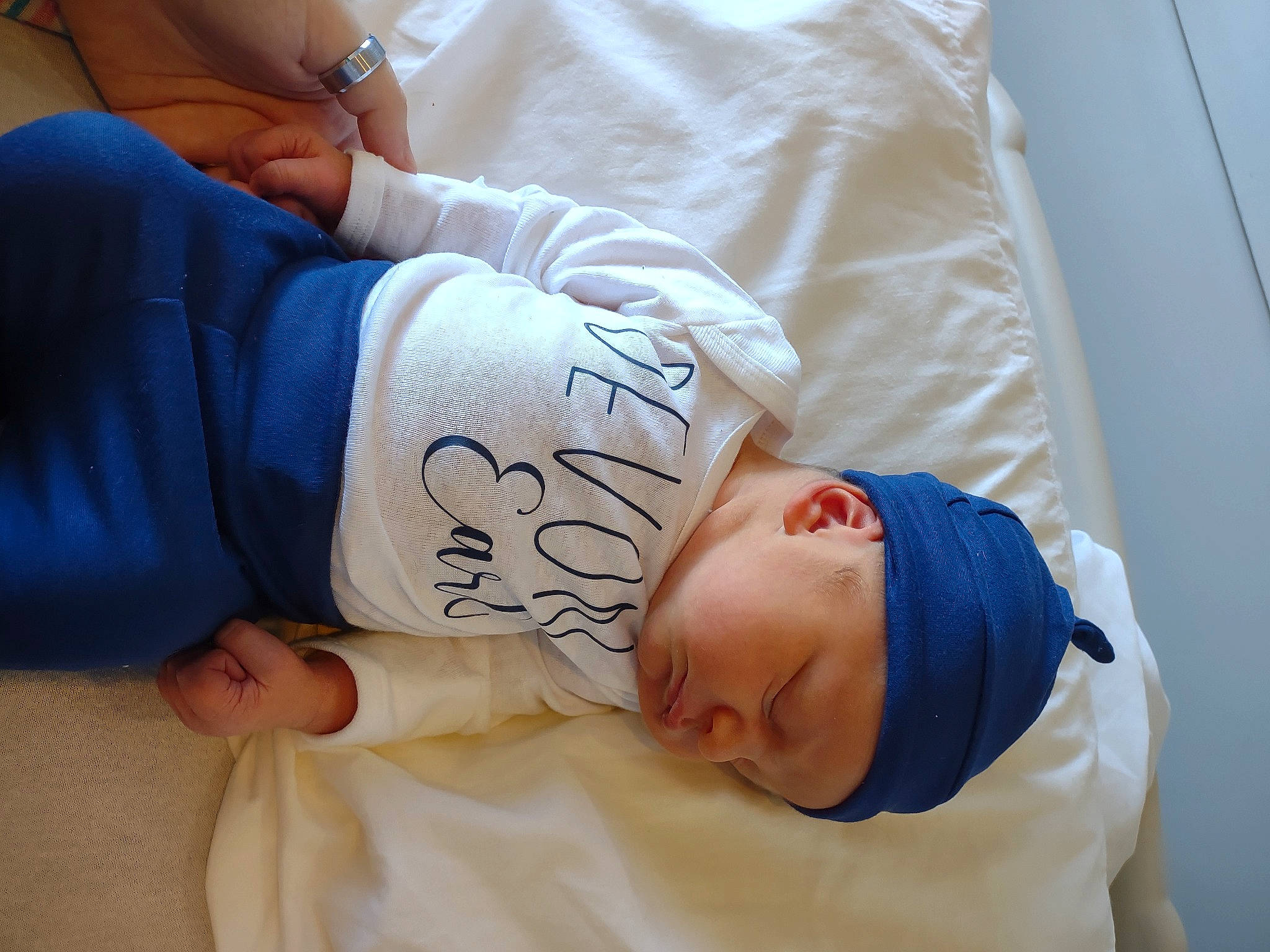 Devon is registered to the contest to win money with this photo: abdomen, baby, baby_sleeping, bed, bedding, bedtime, comfort, elbow, hat, headwear, hospital, hospital_bed, human_body, knee, linens, patient, person, service, shoulder, thigh