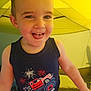 toddler, child, smiling, tank_top, monster_truck, fireworks, indoor, tent, yellow, cute, happy, face, portrait, clothing, arms, baby, person, young_child, fun, playful
