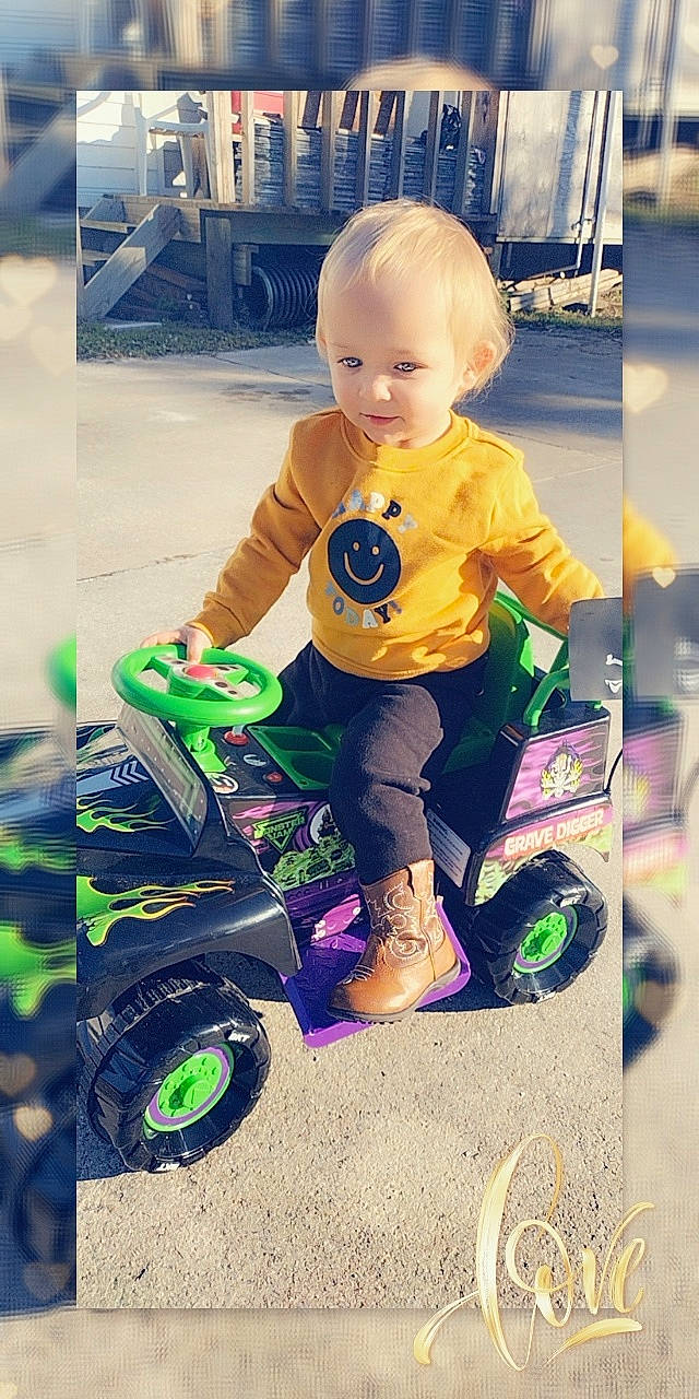 Bentlee is registered to the contest to win money with this photo: baby, baby_toddler_clothing, child, cool, font, fun, grass, happy, person, photograph, play, product, recreation, rolling, sitting, snapshot, sneakers, t_shirt, tire, toddler