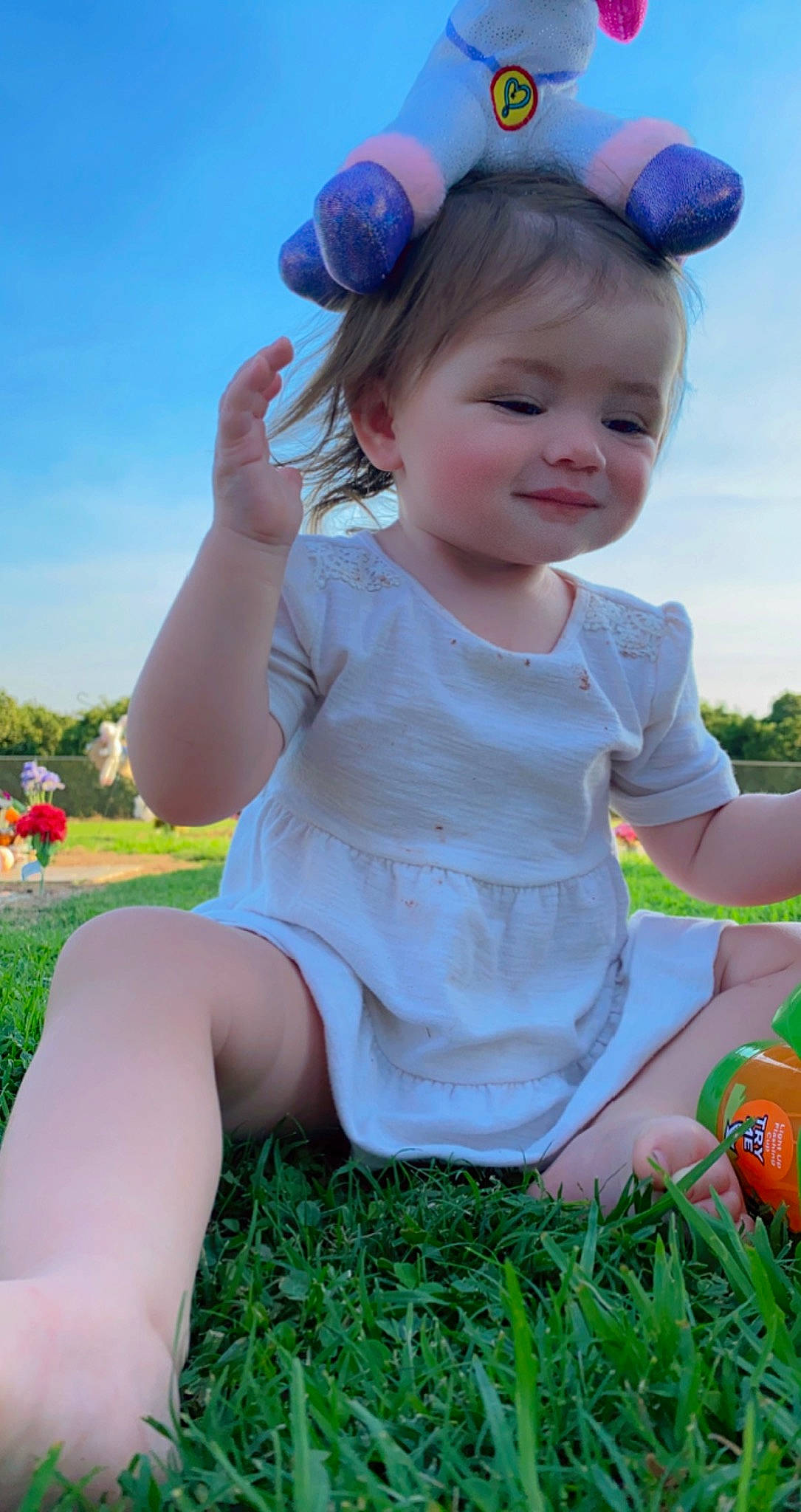 Isabella Faye is registered to the contest to win money with this photo: baby_toddler_clothing, blue, child, facial_expression, finger, fun, grass, green, happy, light, people_in_nature, person, photograph, pink, plant, shorts, skin, sky, t_shirt, toddler