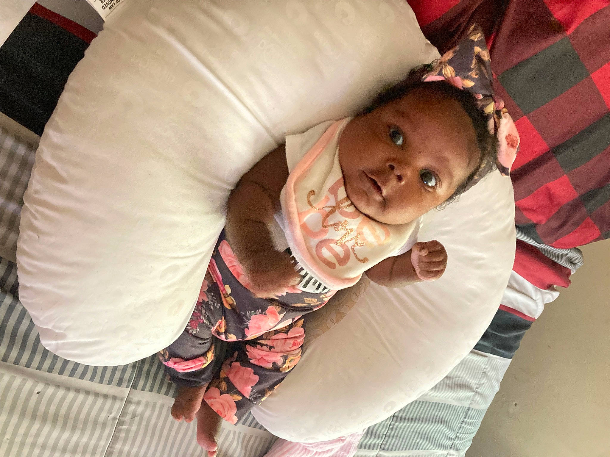 Ariya joined the competition — help win amazing prizes! abdomen, arm, baby, chest, child, comfort, couch, elbow, foot, fun, happy, human_leg, mouth, person, pink, sandal, sitting, smile, tartan, thigh