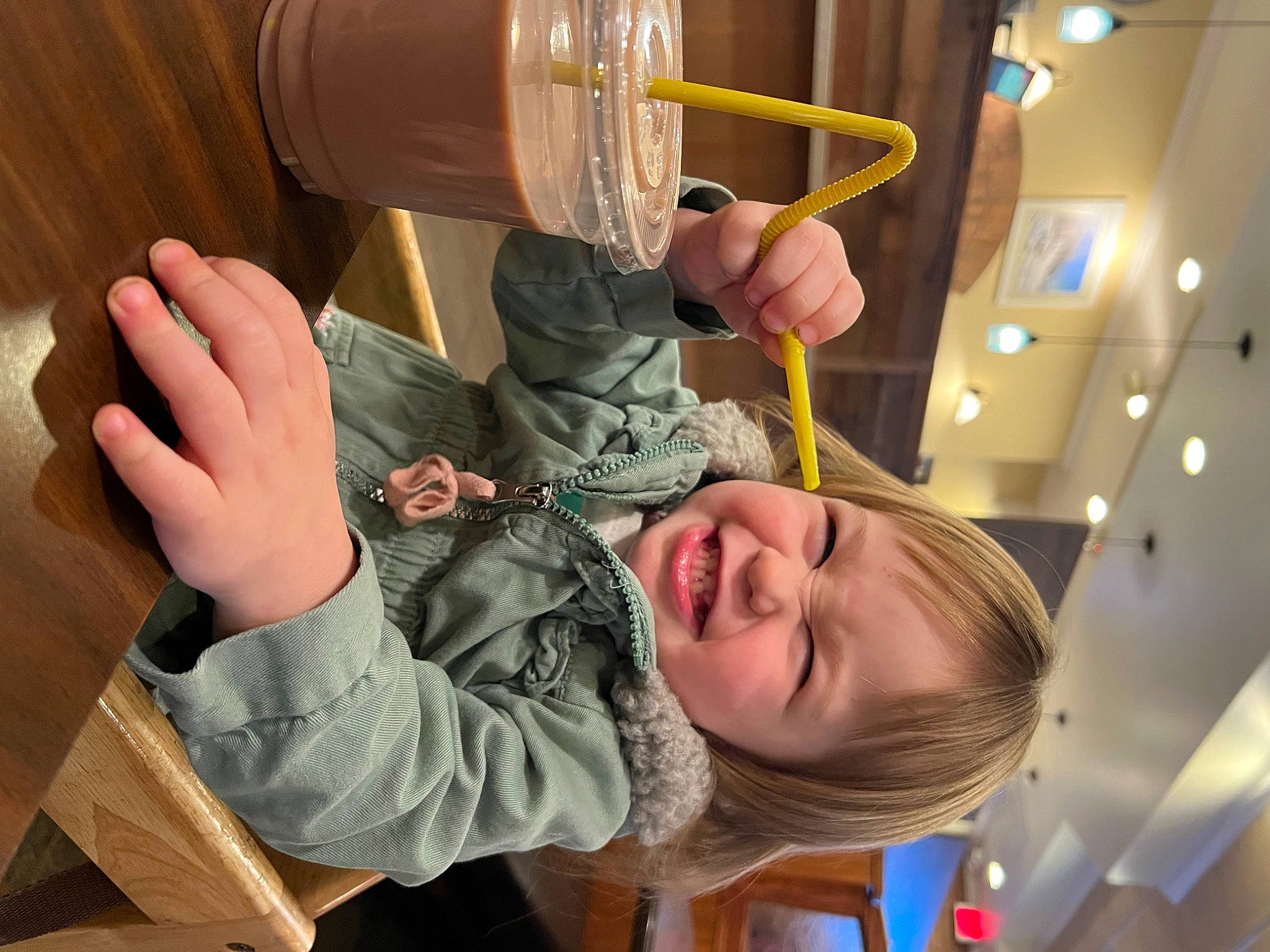 Nyla joined the competition — help win amazing prizes! barware, beer_glass, child, drink, drinking, drinkware, finger, gesture, glass, hand, happy, kitchen_utensil, nail, person, smile, tableware, thumb, toddler, wood, wrist