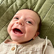 Jayce joined the competition — help win amazing prizes! baby, smiling, face, infant, clothing, quilt, blanket, expression, cute, portrait, happy, skin, head, eyes, mouth, button, fabric, indoors, child, person