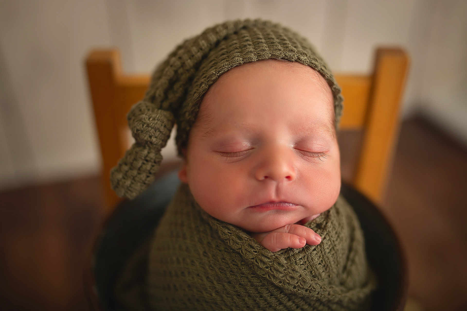 Jayce joined the competition — help win amazing prizes! newborn, baby, sleeping, knitted_hat, blanket, infant, peaceful, portrait, closeup, soft_focus, wooden_chair, wrapped, child, indoors, cute, skin, hand, peace, rest, warm_tones