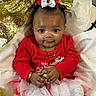 baby, infant, child, gold_bow, red_shirt, tutu, gold_glitter, necklace, bracelet, ornament, smile, big_eyes, portrait, sitting, fabric, festive, holiday, cute, hands, soft_background