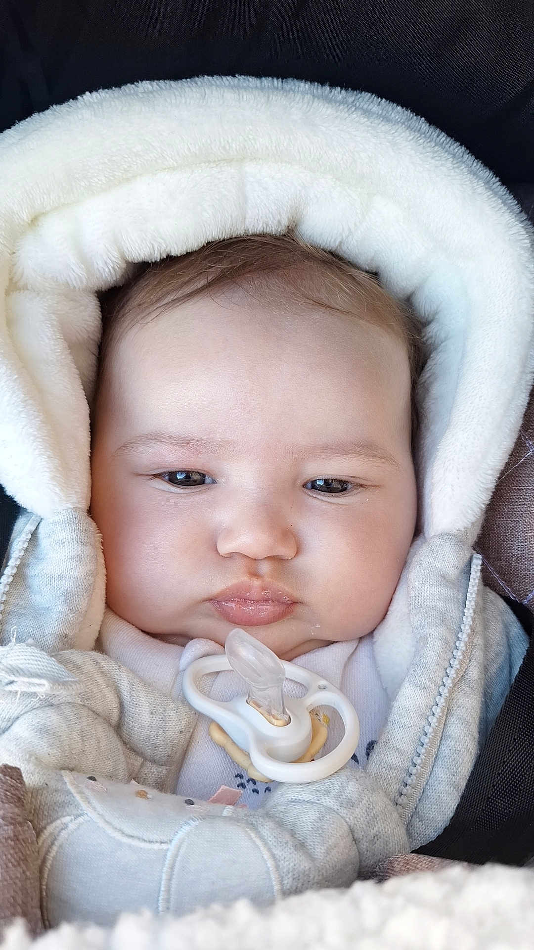 Nour participe au concours pour gagner de l'argent avec cette photo : baby, pacifier, hood, jacket, clothing, face, infant, child, cute, warm, soft, bundle, closeup, portrait, expressionless, indoors, skin, young, small, cozy
