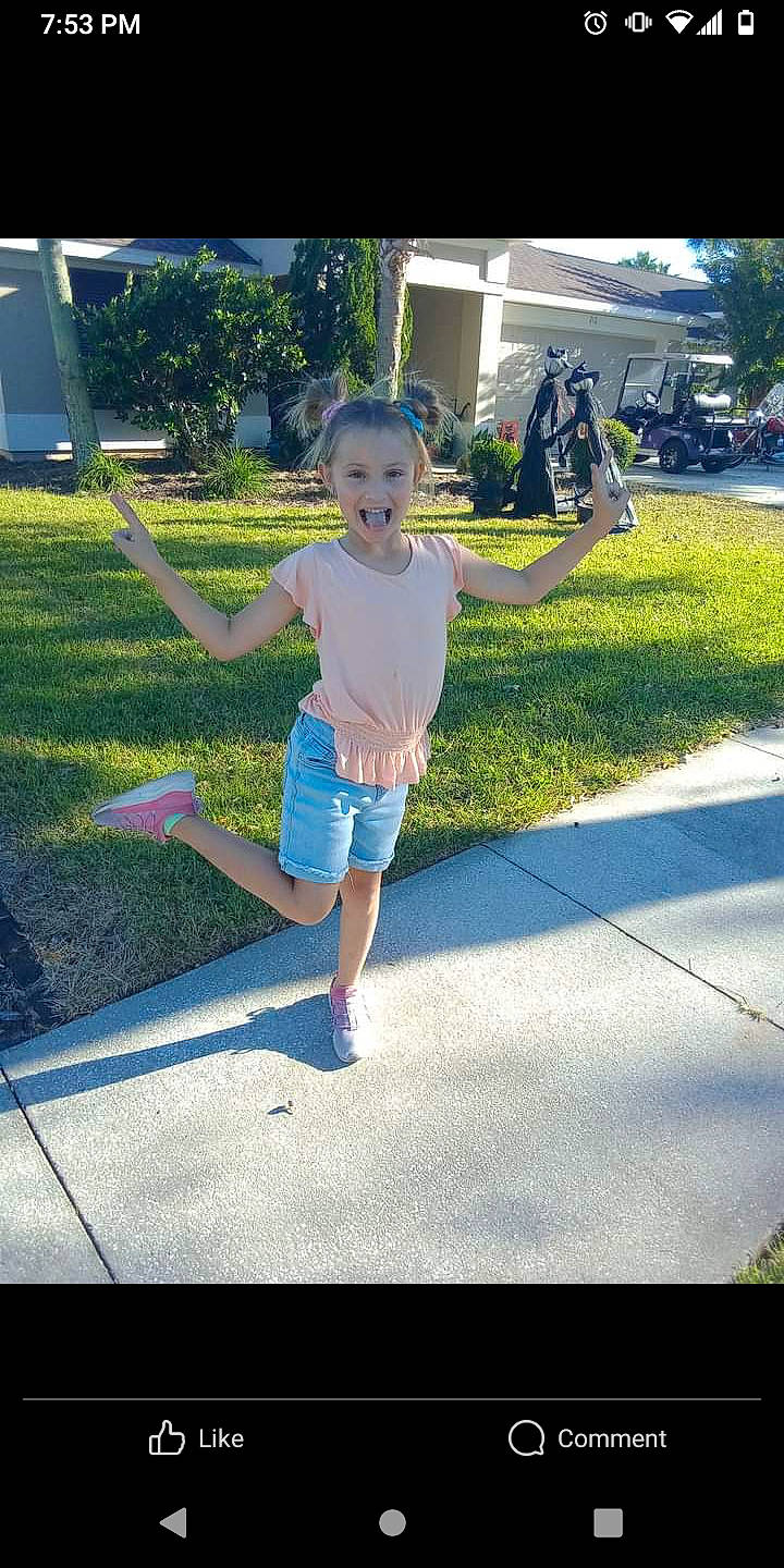 Brooke is registered to the contest to win money with this photo: asphalt, barefoot, city, electric_blue, fun, grass, happy, lawn, leisure, person, plant, recreation, road, shade, shadow, shorts, sidewalk, t_shirt, tints_and_shades, toddler