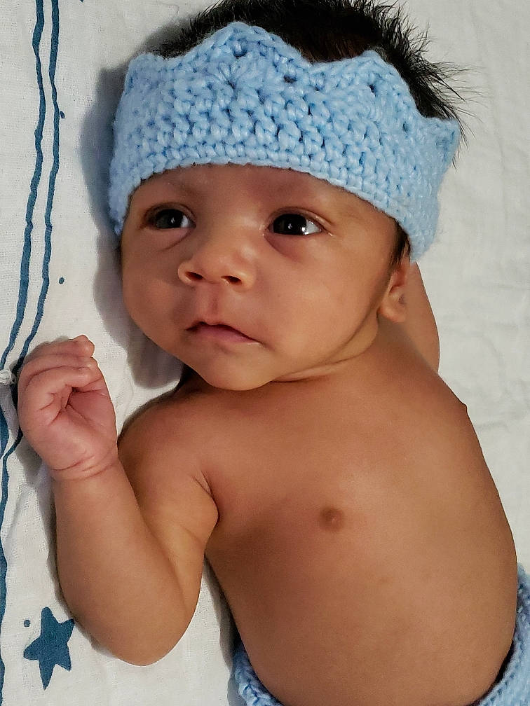 Jairo is registered to the contest to win money with this photo: baby, baby_toddler_clothing, beanie, bonnet, cap, cheek, child, clothing, costume_accessory, crochet, fashion_accessory, hat, head, headgear, headwear, knit_cap, neck, person, skin, toddler