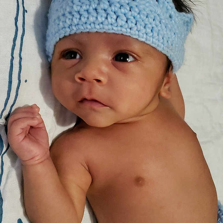 Jairo is registered to the contest to win money with this photo: baby, baby_toddler_clothing, beanie, bonnet, cap, cheek, child, clothing, costume_accessory, crochet, fashion_accessory, hat, head, headgear, headwear, knit_cap, neck, person, skin, toddler