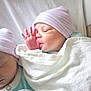 newborn, baby, infant, twin_babies, swaddled, hospital_hat, striped_hat, blanket, sucking_thumb, hand, face, sleeping, portrait, close_up, skin, bed, nursery, cute, hospital, newborn_hat