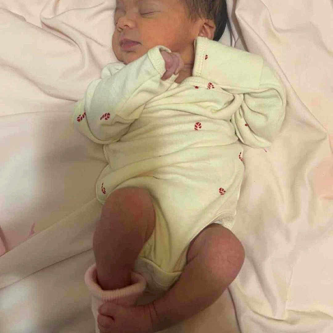 De'Nae joined the competition — help win amazing prizes! baby, bed_sheet, blanket, cozy, face, foot, hair, head, infant, lying_down, newborn, nursery, onesie, peaceful, pink, portrait, sleeping, sock, soft_fabric, toes