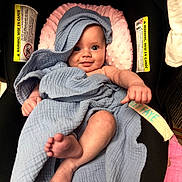 Riley Faye joined the competition — help win amazing prizes! baby, blanket, blue_blanket, infant, smiling, face, feet, hand, seat, cushion, warning_label, towel, cozy, cute, child, wrapped, indoors, comfort, happy, portrait