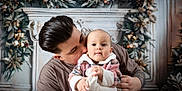 Autumn-Rose is registered to the contest to win money with this photo: baby, adult, parent, child, plaid, pajamas, holding, kissing, face, portrait, holiday, christmas, wreath, decorations, indoor, love, tenderness, smile, cute, family