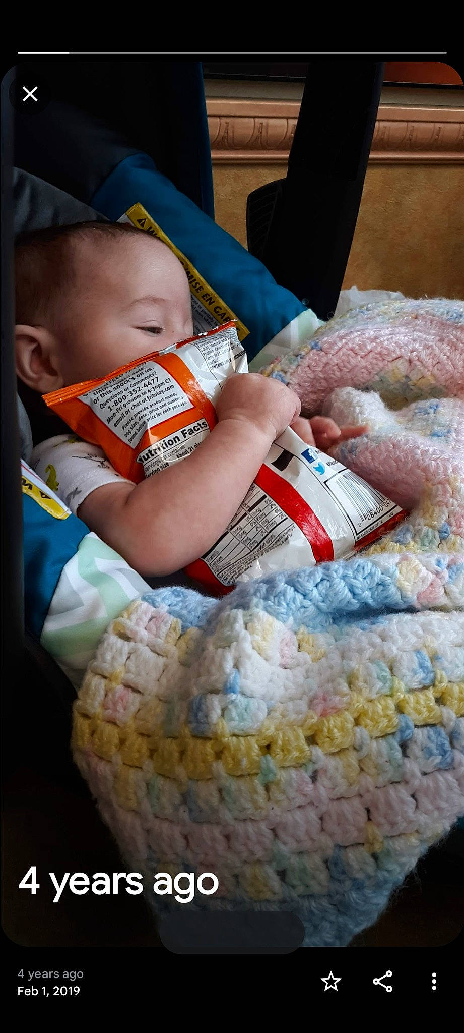 Christopher is registered to the contest to win money with this photo: baby, baby_toddler_clothing, child, comfort, linens, pattern, person, personal_protective_equipment, plastic_bag, sitting, toddler