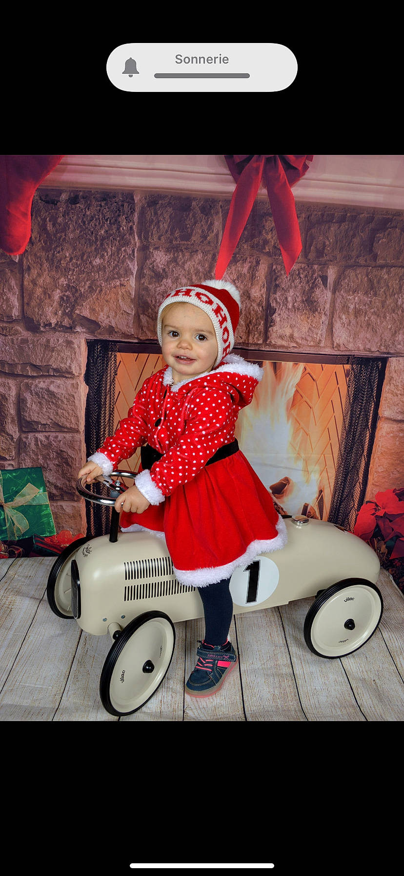 Maeva a rejoint le concours — aidez-le/la à gagner de superbes lots ! automotive_wheel_system, baby, baby_toddler_clothing, boot, child, event, fun, happy, hat, headwear, holiday, joy, magenta, person, pink, product, red, riding_toy, sitting, smile