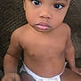 Nico joined the competition — help win amazing prizes! baby, toddler, child, diaper, sitting, indoor, brown_skin, couch, expression, curious, face, eyes, head, arm, hand, shoulder, torso, infant, person, portrait