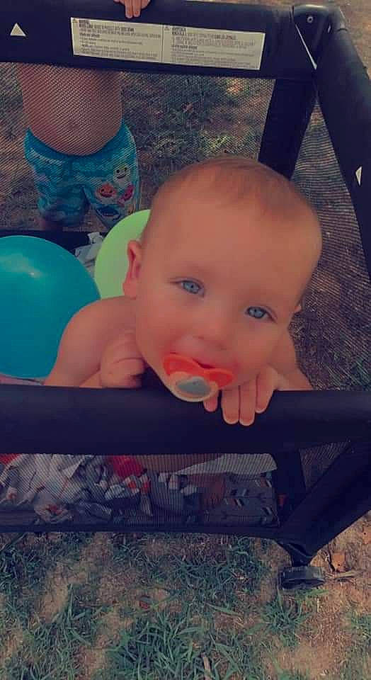 Dorian is registered to the contest to win money with this photo: baby, cheek, child, cloud, cool, eye, finger, flooring, fun, grass, hairstyle, happy, head, mouth, person, pink, sitting, skin, smile, tints_and_shades