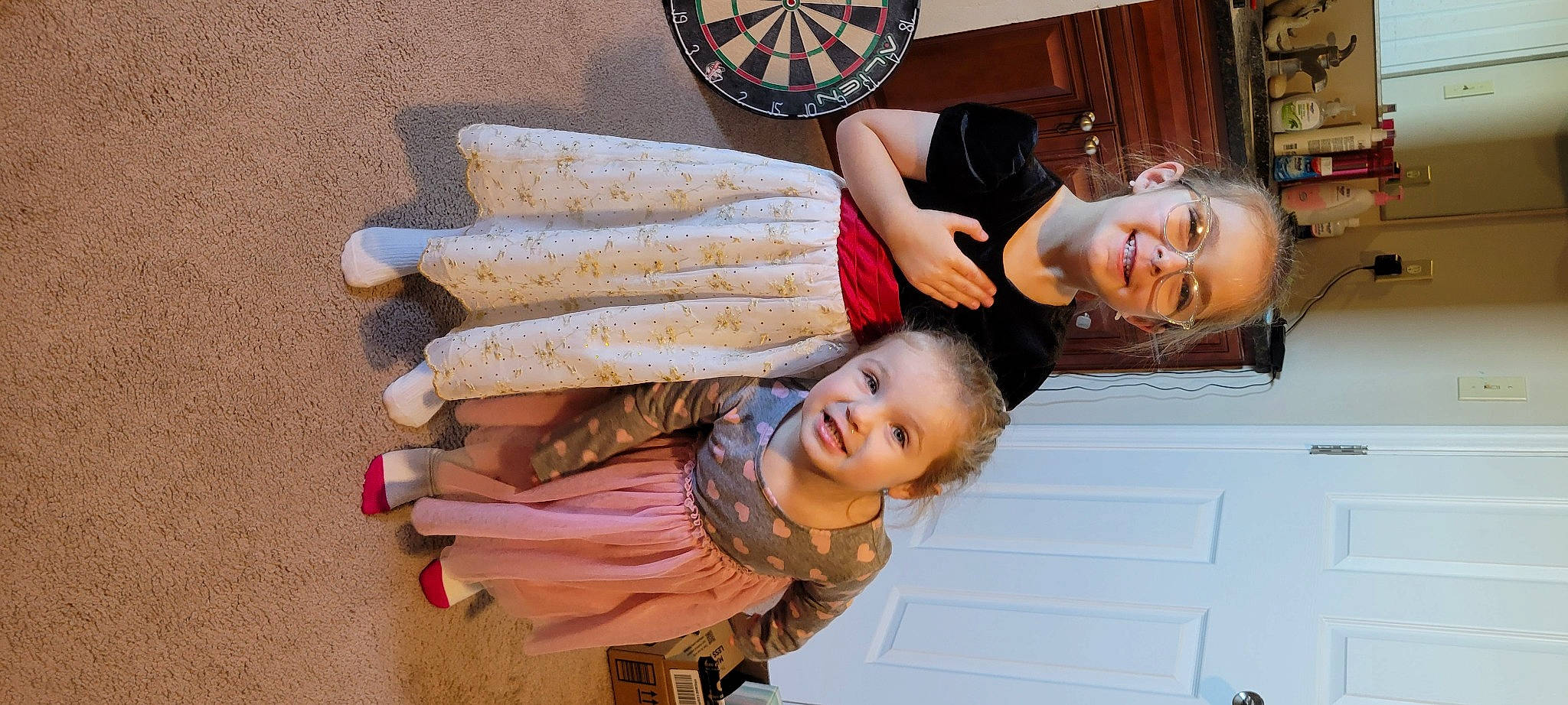 Charlotte is registered to the contest to win money with this photo: child, dartboard, darts, event, eyewear, fun, happy, joy, leisure, mechanical_fan, person, plate, room, shelf, sitting, smile, travel, wood