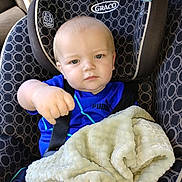 Riot joined the competition — help win amazing prizes! baby, blanket, blanket_texture, blue_shirt, car_interior, car_seat, child, clothing, comfort, expression, face, headrest, indoors, portrait, puma_logo, safety, seatbelt, sitting, toddler, young_child
