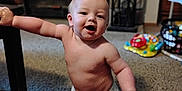 Riot is registered to the contest to win money with this photo: baby, carpet, child, cute, diaper, face, furniture, happy, home, indoor, infant, kneeling, person, play, room, skin, smiling, table, toy, young
