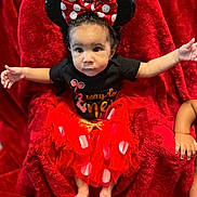 Nova joined the competition — help win amazing prizes! baby, barefoot, black_shirt, blanket, bow, child, cute, expression, face, happy, indoors, infant, mickey_ears, plush, polka_dot, portrait, red, sitting, skirt, tutu