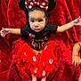 baby, barefoot, black_shirt, blanket, bow, child, cute, expression, face, happy, indoors, infant, mickey_ears, plush, polka_dot, portrait, red, sitting, skirt, tutu