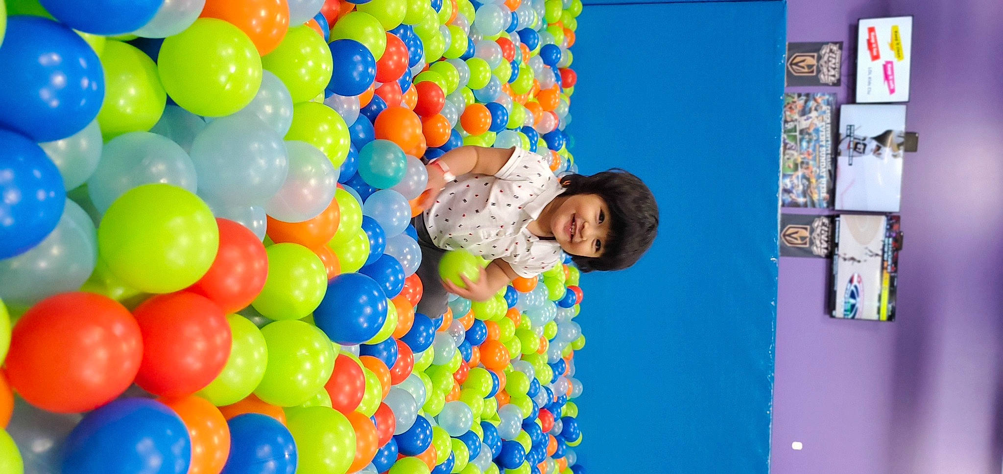 Ethan is registered to the contest to win money with this photo: ball_pit, balloon, child, electric_blue, event, fun, happy, joy, leisure, party, party_supply, person, play, product, recreation, room, smile, t_shirt, toy