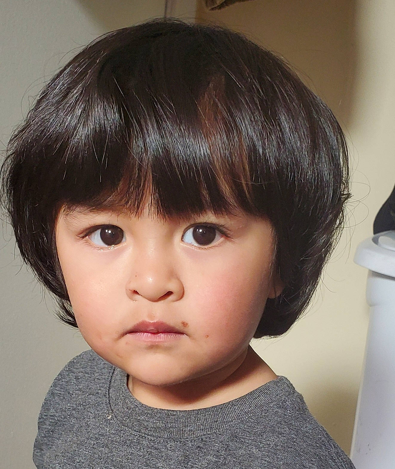 Ethan is registered to the contest to win money with this photo: bangs, black_hair, cheek, chin, ear, eyelash, forehead, hime_cut, iris, jaw, layered_hair, lip, long_hair, neck, no_expression, nose, person, step_cutting, toddler, wig