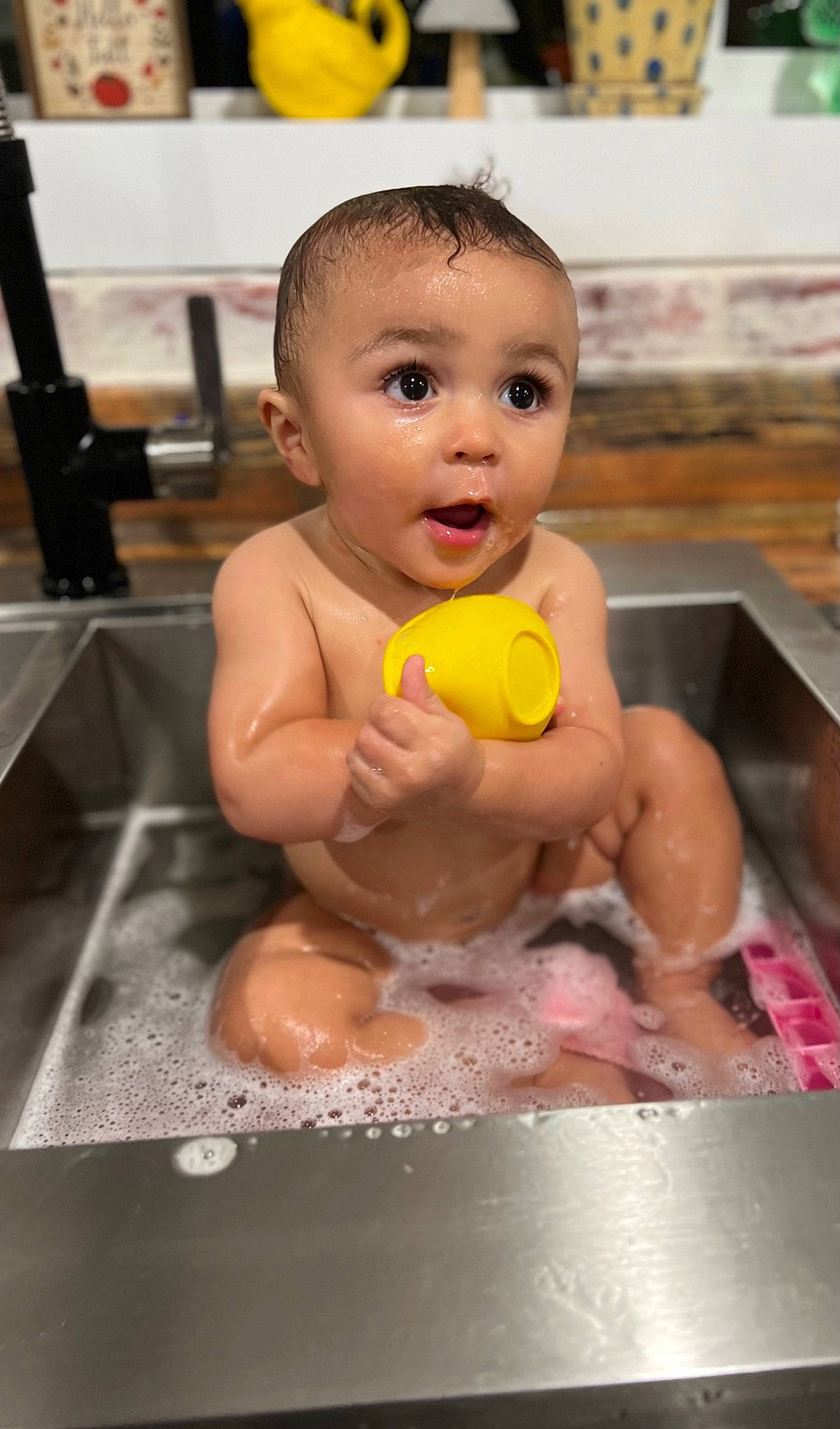 Mak is registered to the contest to win money with this photo: baby, bath_toy, bathing, cheek, chest, child, finger, flooring, foot, fun, happy, leisure, mouth, person, product, recreation, sink, skin, surprise, toddler