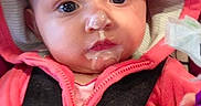 Lola joined the competition — help win amazing prizes! baby, child, hoodie, pink_clothing, black_harness, face, messy_face, milk, food, curious, indoor, infant, person, cute, closeup, expression, young_child, clothing, seatbelt, portrait