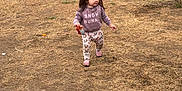 Miyrah joined the competition — help win amazing prizes! toddler, child, walking, outdoor, grass, field, nature, sweatshirt, snack, pants, hair, top_knot, post, dry_grass, casual_clothing, daytime, person, small_child, holding, cute