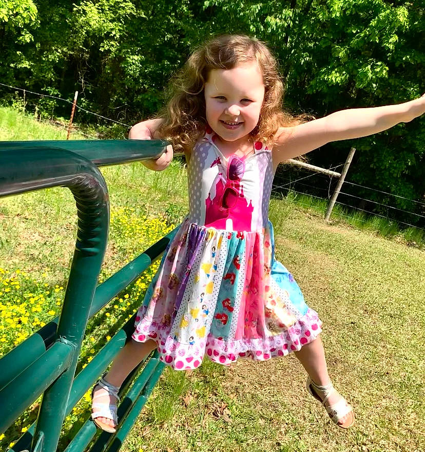 Railynn is registered to the contest to win money with this photo: baby_toddler_clothing, beauty, child, fun, grass, grass_family, happy, joy, lawn, leisure, magenta, pattern, people_in_nature, person, plant, recreation, smile, summer, sunlight, tints_and_shades