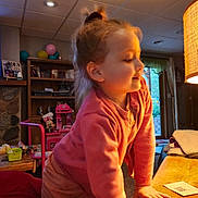 Giana joined the competition — help win amazing prizes! balloons, carpet, child, cozy, curtains, hair_tied, indoor, lamp, living_room, minnie_mouse, person, pink_clothing, playful, smiling, table, toys, warm_lighting, window, wooden_furniture, young_child