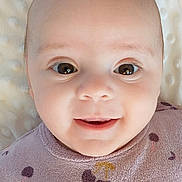 Rose participe au concours pour gagner de l'argent avec cette photo : baby, blanket, cherry, child, clothing, cute, eyes, face, happy, head, indoors, infant, lying, pattern, portrait, purple, smile, soft, texture, young