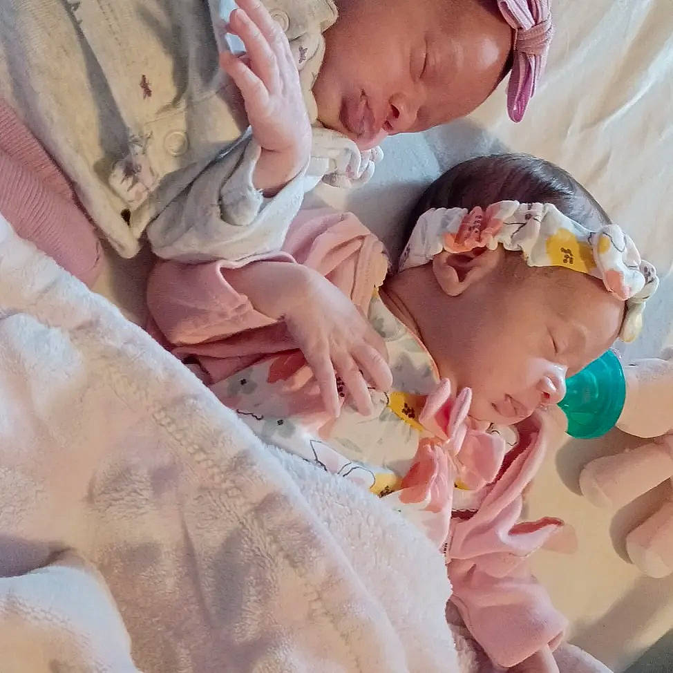 Aria is registered to the contest to win money with this photo: baby, baby_toddler_clothing, cap, child, comfort, ear, eyelash, finger, gesture, hand, happy, hat, human_body, mammal, nose, person, pink, skin, textile, thumb