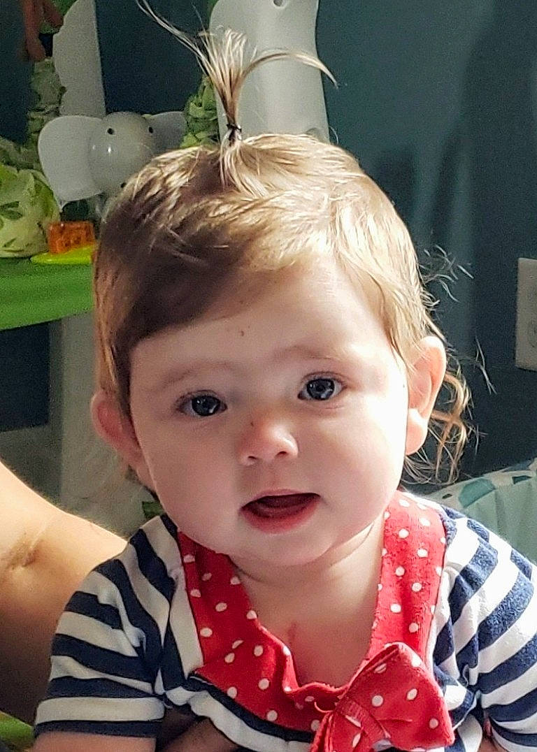 Quinn is registered to the contest to win money with this photo: baby, brown_hair, child, ear, face, fashion_accessory, forehead, hair, hair_accessory, hairstyle, head, lip, neck, person, polka_dot, toddler