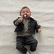 Giuseppe participe au concours pour gagner de l'argent avec cette photo : baby, infant, pacifier, clothing, jacket, pants, sneakers, blanket, lying_down, cute, young_child, white_background, fashion, child, portrait, casual, indoor, soft_texture, comfortable, adorable