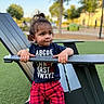 toddler, child, outdoor, park, chair, clothing, alphabet, red_pants, grass, daylight, ponytail, cute, portrait, playground, person, smiling, hand, casual, young, nature