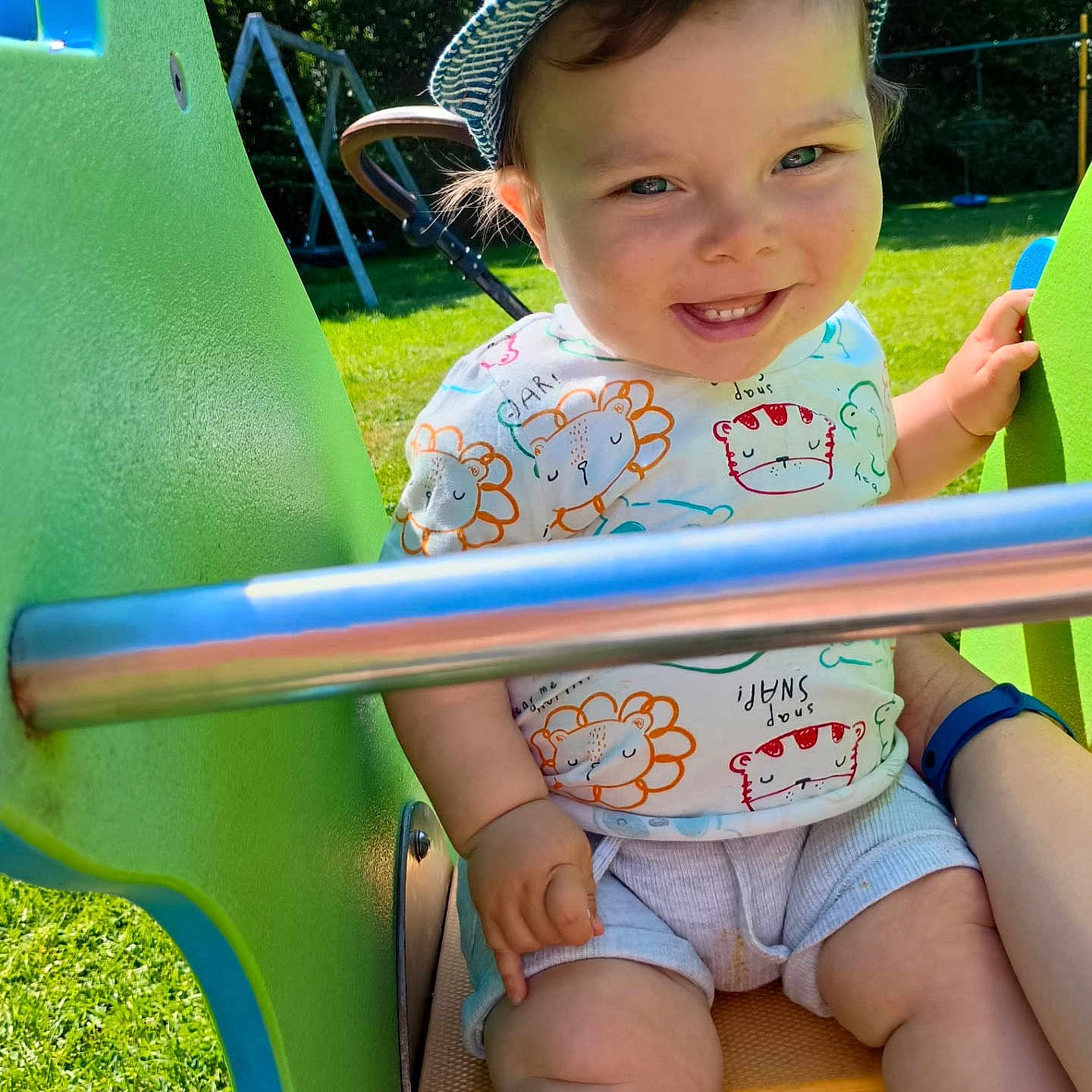 Oliver is registered to the contest to win money with this photo: baby, baseballcap, cap, clothing, face, furniture, grass, hat, head, nature, outdoorplayarea, outdoors, park, person, photography, plant, playarea, portrait, shorts, summer